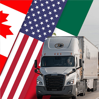Truck in front of Canada, USA, and Mexico flags.
